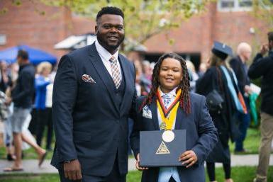 T.J. Saddler let his son hold his degree and wear his hardware at commencement on May 8, 2022.